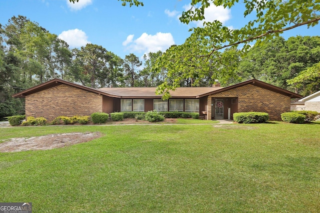 25 Golf Club Cir, Statesboro, GA 30458 - ranch-style home with brick siding, a chimney, and a front yard
