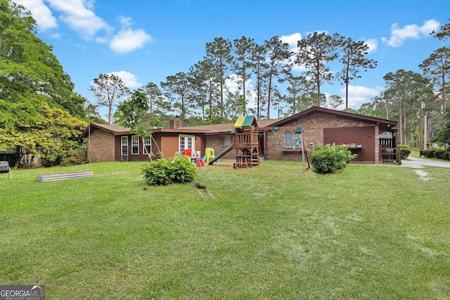 25 Golf Club Cir, Statesboro, GA 30458 - rear view of house with a playground, a chimney, a lawn, and brick siding
