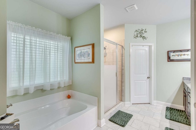 bathroom featuring vanity, visible vents, tile patterned flooring, a shower stall, and a garden tub