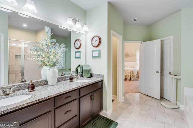 full bath with a sink, double vanity, ensuite bath, and a stall shower