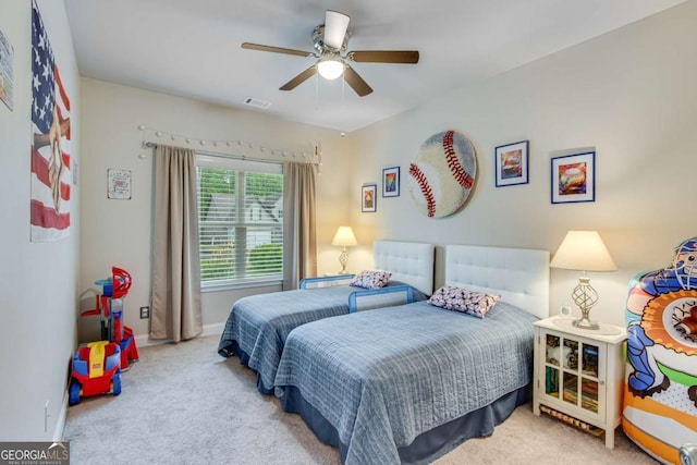 bedroom with baseboards, a ceiling fan, visible vents, and carpet