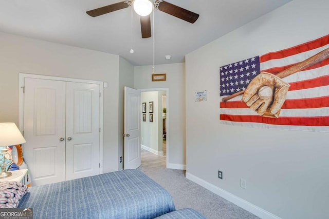 carpeted bedroom featuring baseboards, a closet, and a ceiling fan