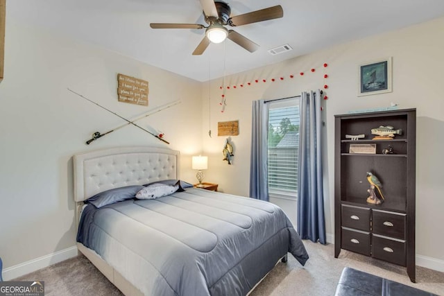 carpeted bedroom with ceiling fan, baseboards, and visible vents