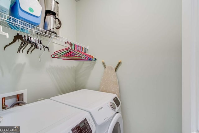 clothes washing area with separate washer and dryer and laundry area