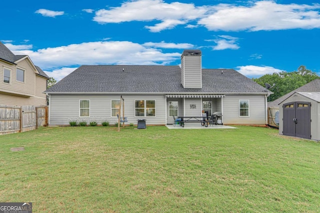 rear view of property featuring a storage shed, a patio area, an outbuilding, a fenced backyard, and a lawn
