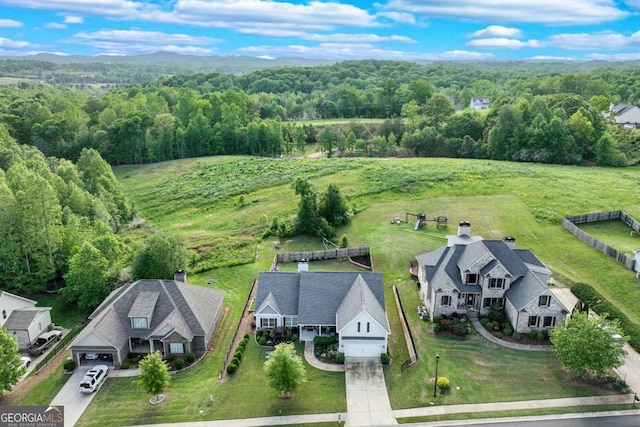 drone / aerial view featuring a forest view