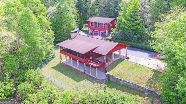 drone / aerial view featuring a forest view