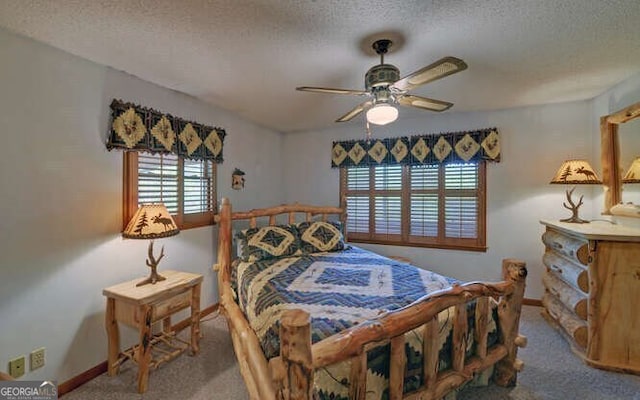 bedroom featuring a textured ceiling, carpet, baseboards, and multiple windows