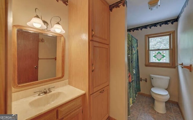 bathroom with toilet, baseboards, a shower with shower curtain, tile patterned floors, and vanity