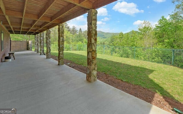 view of patio featuring a fenced backyard and a view of trees