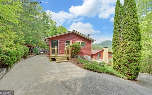 view of front of property featuring concrete driveway and a mountain view