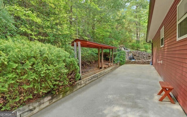 view of patio with a view of trees