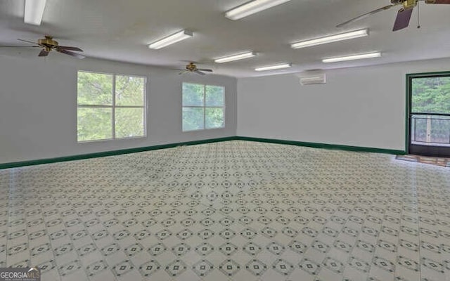 empty room featuring a ceiling fan and baseboards