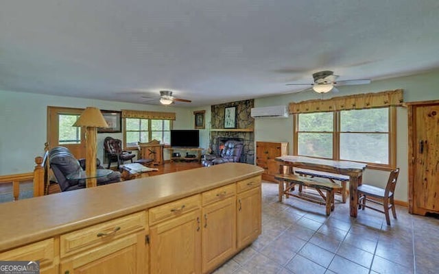 kitchen with a wealth of natural light, a ceiling fan, and a wall mounted AC