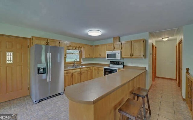 kitchen with white microwave, stainless steel refrigerator with ice dispenser, light brown cabinetry, light tile patterned floors, and electric range oven