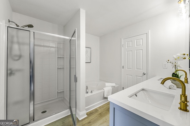 3460 Lockmed Dr, Peachtree Corners, GA 30092 - full bathroom with wood finished floors, a stall shower, a garden tub, and double vanity