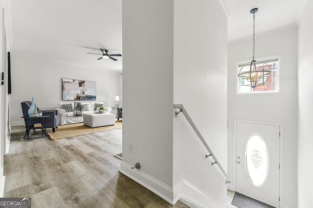 3460 Lockmed Dr, Peachtree Corners, GA 30092 - entrance foyer featuring a chandelier, ornamental molding, wood finished floors, and a ceiling fan