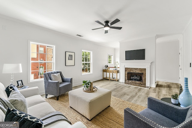 3460 Lockmed Dr, Peachtree Corners, GA 30092 - living area featuring ornamental molding, ceiling fan, light wood-type flooring, and a premium fireplace