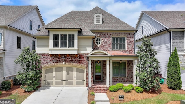 919 Olmsted Ln, Johns Creek, GA 30097 - view of front of house with concrete driveway, brick siding, a shingled roof, and a garage