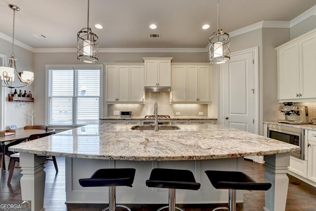 919 Olmsted Ln, Johns Creek, GA 30097 - kitchen featuring stainless steel microwave, tasteful backsplash, visible vents, recessed lighting, and dark wood finished floors