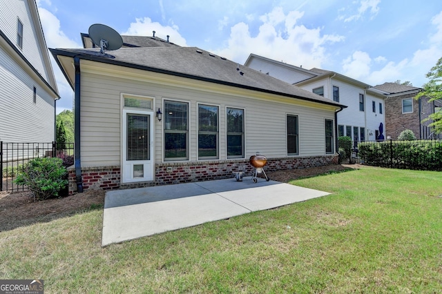 919 Olmsted Ln, Johns Creek, GA 30097 - back of house featuring brick siding, a patio area, fence, and a lawn