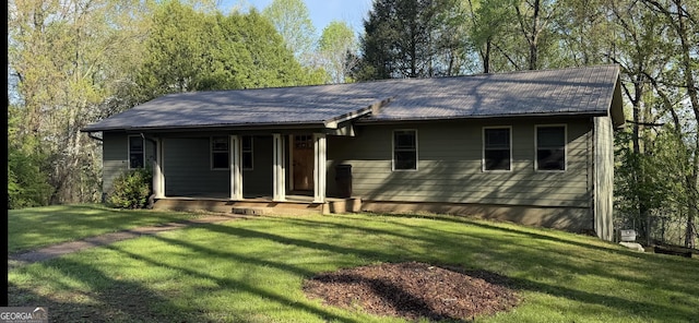 view of front of house with covered porch, metal roof, and a front yard