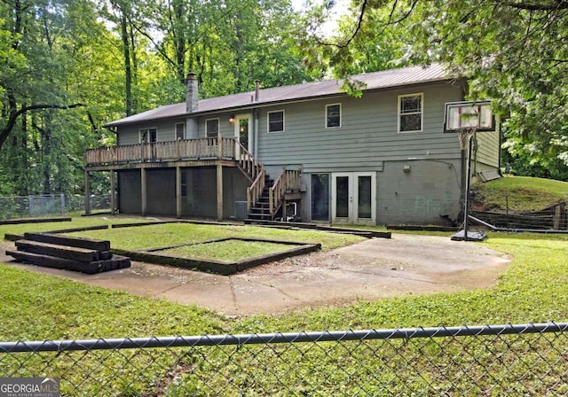 back of house with stairs, fence, a patio, a wooden deck, and a lawn