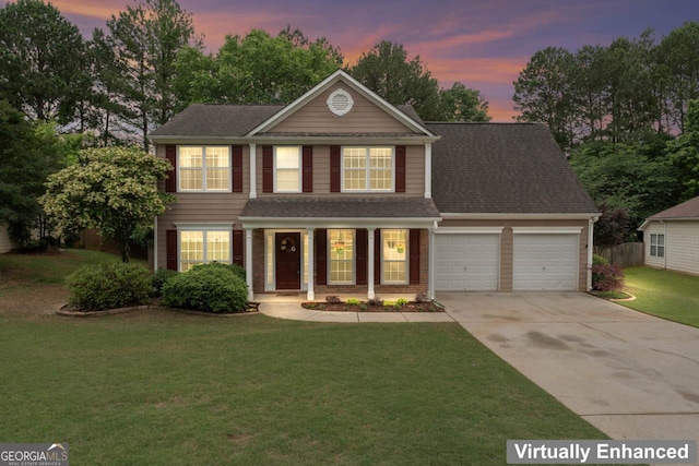 traditional home featuring a lawn, driveway, covered porch, an attached garage, and a shingled roof