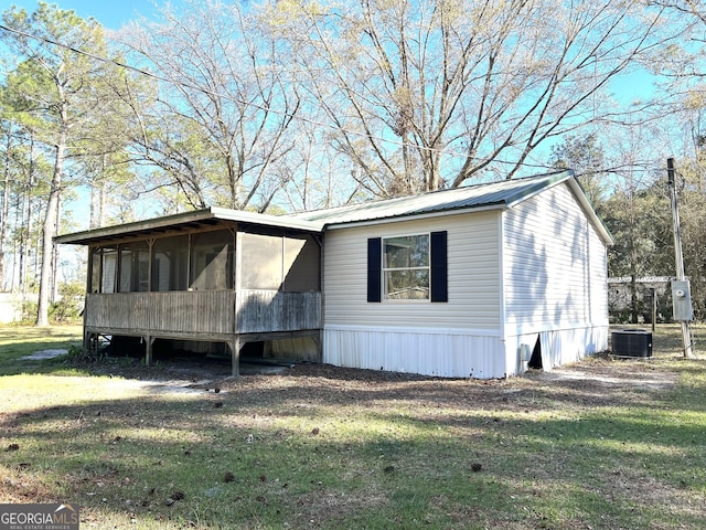 104 Scattered Pines Rd, Hortense, GA 31543 - view of home's exterior featuring a sunroom, a lawn, and central air condition unit