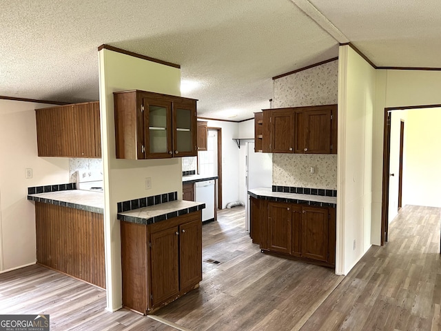 104 Scattered Pines Rd, Hortense, GA 31543 - kitchen with ornamental molding, wood finished floors, white dishwasher, a textured ceiling, and glass insert cabinets