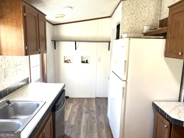104 Scattered Pines Rd, Hortense, GA 31543 - kitchen featuring a sink, wood finished floors, freestanding refrigerator, crown molding, and stainless steel dishwasher