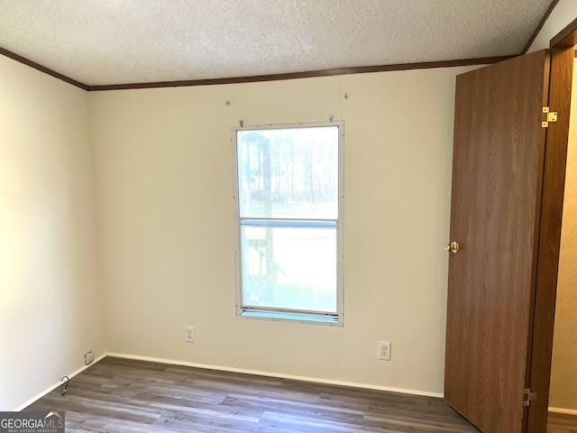 104 Scattered Pines Rd, Hortense, GA 31543 - spare room with crown molding, a textured ceiling, baseboards, and dark wood-style floors