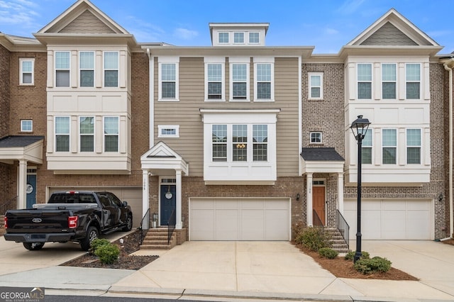 1098 Caruso Dr, Buford, GA 30518 - townhome / multi-family property with an attached garage, driveway, and brick siding