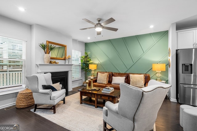 1098 Caruso Dr, Buford, GA 30518 - living area with healthy amount of natural light, wood finished floors, a ceiling fan, a decorative wall, and recessed lighting