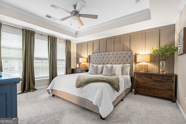 1098 Caruso Dr, Buford, GA 30518 - bedroom with light colored carpet, a ceiling fan, a raised ceiling, ornamental molding, and a decorative wall