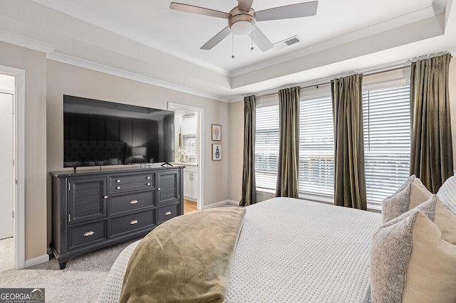 1098 Caruso Dr, Buford, GA 30518 - bedroom with crown molding, a ceiling fan, a raised ceiling, light carpet, and ensuite bath