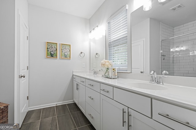 1098 Caruso Dr, Buford, GA 30518 - bathroom featuring double vanity, healthy amount of natural light, and a tile shower