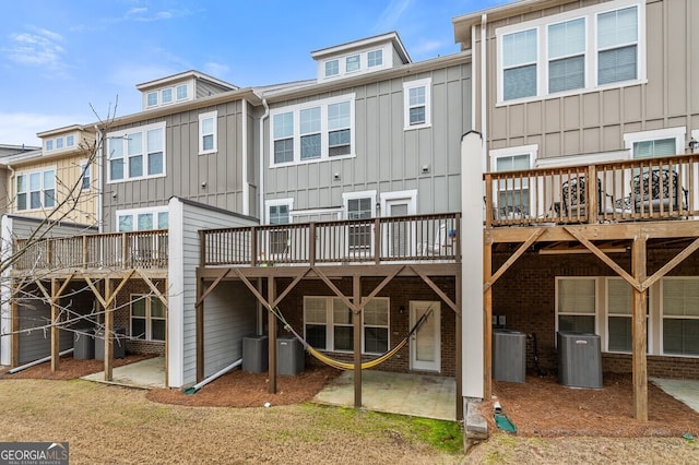 1098 Caruso Dr, Buford, GA 30518 - back of house with board and batten siding and a wooden deck