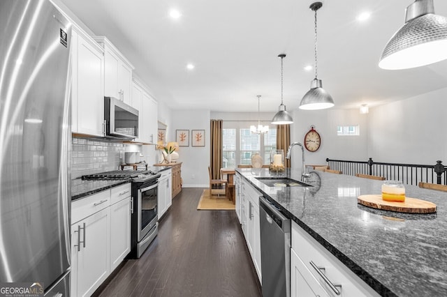 1098 Caruso Dr, Buford, GA 30518 - kitchen with appliances with stainless steel finishes, white cabinets, decorative backsplash, recessed lighting, and a chandelier
