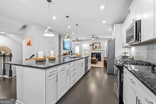 1098 Caruso Dr, Buford, GA 30518 - kitchen featuring stainless steel appliances, an island with sink, recessed lighting, backsplash, and white cabinets