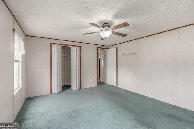 unfurnished bedroom featuring crown molding, a textured ceiling, and carpet floors
