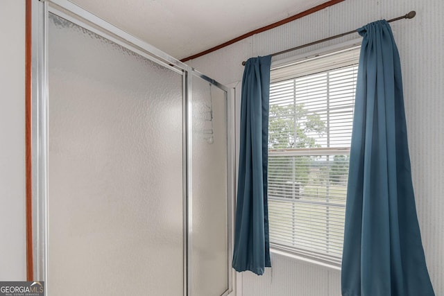 bathroom featuring a stall shower and ornamental molding