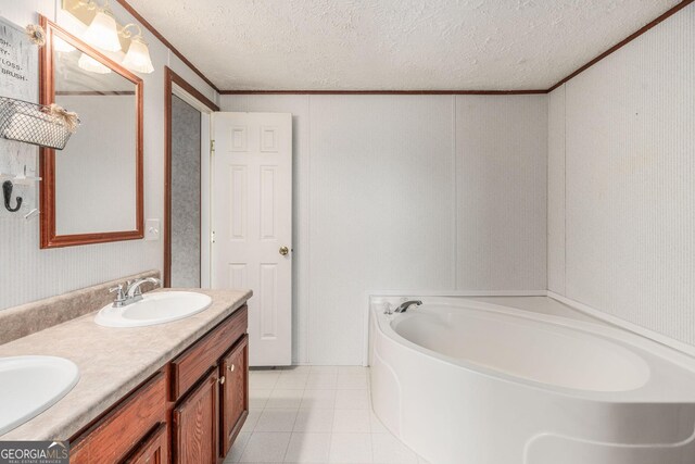 bathroom featuring double vanity, a garden tub, a sink, crown molding, and a textured ceiling