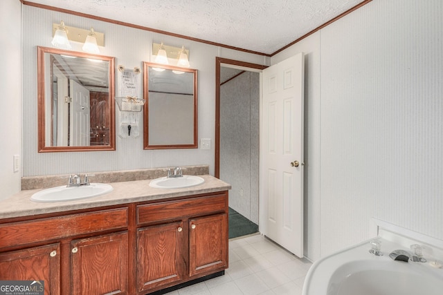bathroom featuring double vanity, crown molding, tile patterned floors, and a sink