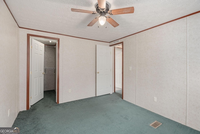 unfurnished bedroom featuring crown molding, carpet, and visible vents