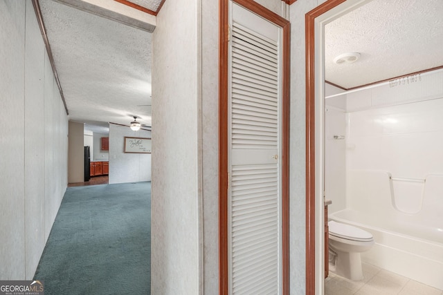hall featuring a textured ceiling