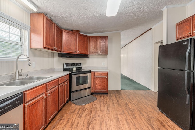 kitchen featuring dishwashing machine, a sink, freestanding refrigerator, stainless steel electric range, and under cabinet range hood