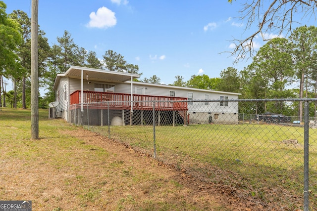 rear view of property featuring a lawn, crawl space, fence, and a wooden deck