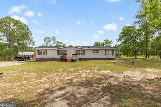 manufactured / mobile home featuring a front yard and crawl space