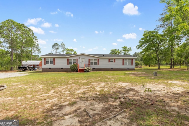 manufactured / mobile home featuring a front yard and crawl space